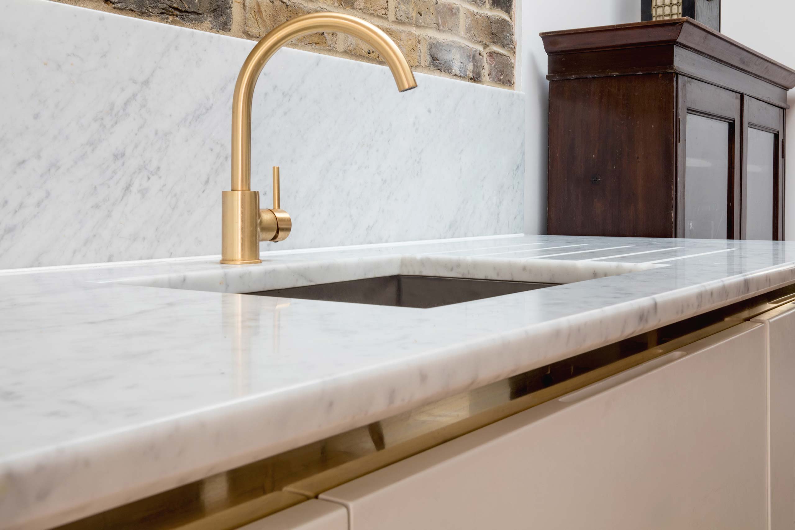 Marble top and brass details in Six Hands kitchen