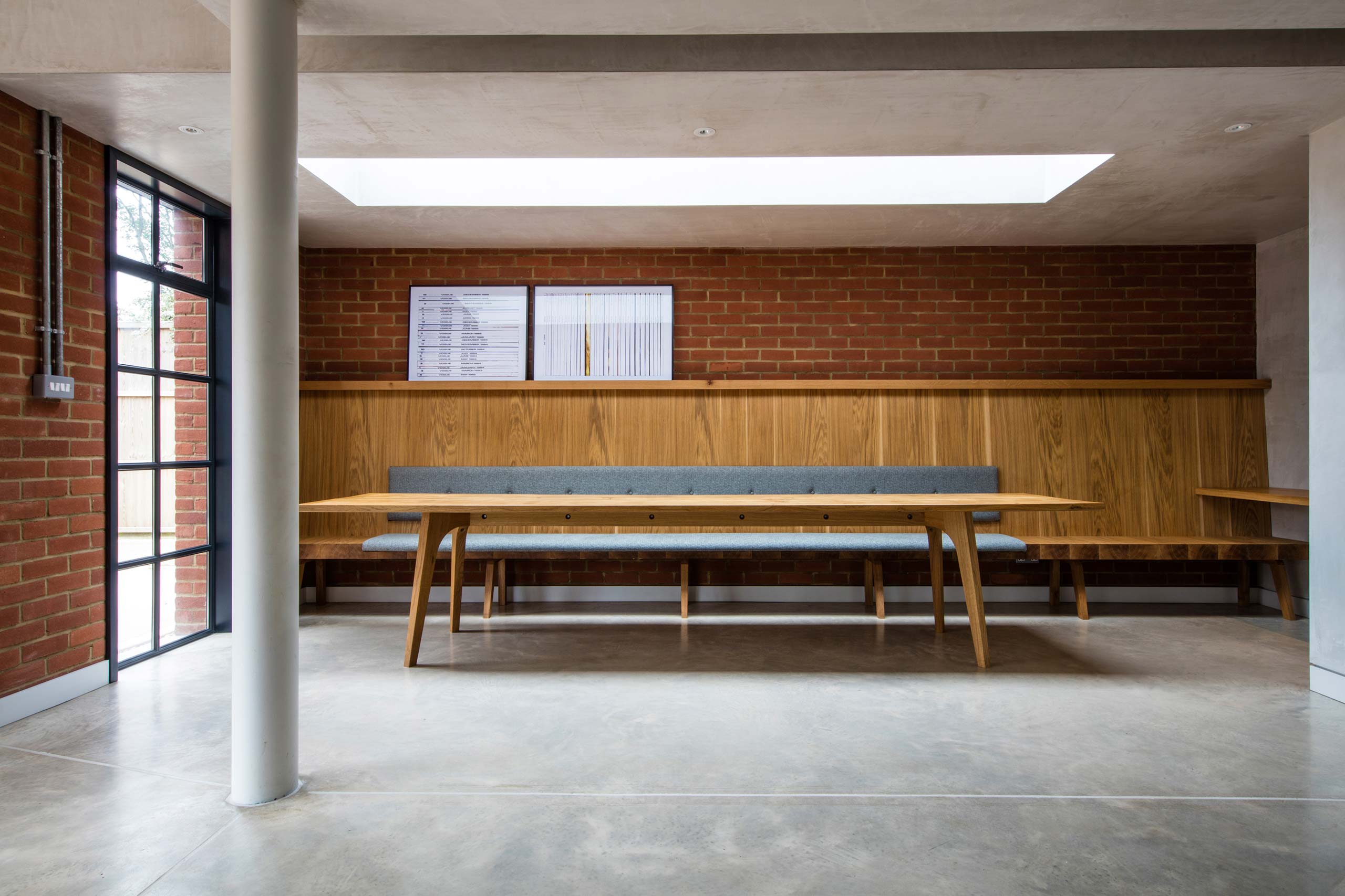 Handmade solid oak dining table and banquette upholstered seating by Six Hands